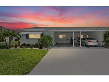 Charming single-story home featuring a covered carport and well-maintained landscaping at 6016 Hibiscus Dr, Bradenton, FL 34207
