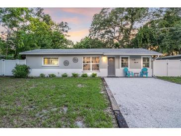 Charming single-story home featuring a well-maintained front lawn and gravel driveway at 946 Charlotte Ave, Sarasota, FL 34237