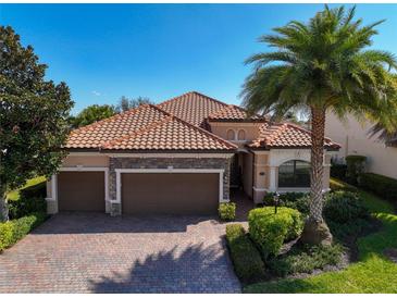 Beautiful single-Gathering home features a well-manicured lawn, large driveway, and a terracotta roof at 13026 Ramblewood Trl, Bradenton, FL 34211