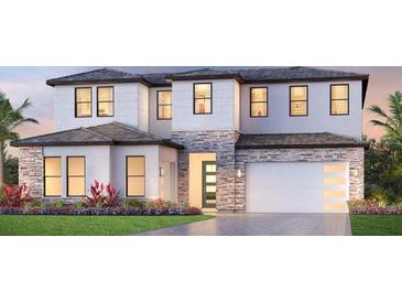 Two-story home with stone accents, a two-car garage, and lush landscaping at 2592 Waterfront Cir, Sarasota, FL 34240