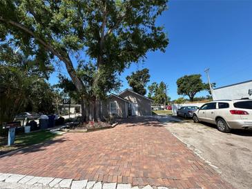 Charming home featuring a brick driveway, complemented by mature trees providing ample shade at 2804 11Th Street E Ct, Bradenton, FL 34208