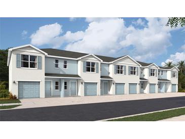 Charming townhome exterior featuring blue accents, a one car garage and well manicured landscaping at 4522 Stargazer Ct, Palm Harbor, FL 34683