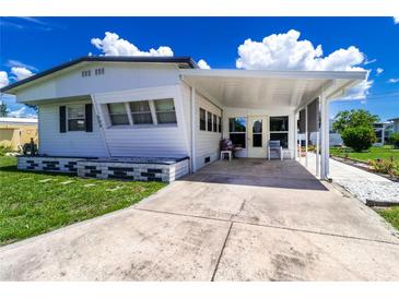 Inviting home exterior with a covered porch and well-maintained lawn and features a long driveway for easy parking at 508 50Th Avenue W Plz, Bradenton, FL 34207