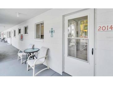 Condo exterior showcasing a cozy seating area and the unit's front door at 2014 Canal Dr # M6, Bradenton, FL 34207