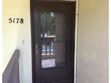 Inviting front door with glass panel and visible address number at 5178 Lake Village Drive # 86, Sarasota, FL 34235