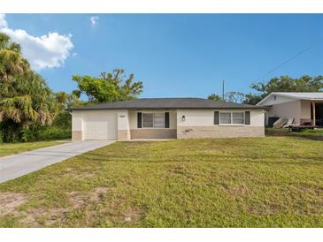 Charming single-story home with a well-manicured lawn and a classic neutral-toned facade at 6961 Alken Cir, New Port Richey, FL 34653