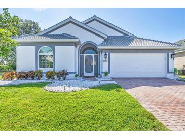 Charming single-story home featuring a beautifully manicured lawn and a two-car garage at 7005 Goldrush Ln, Bradenton, FL 34201