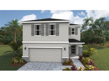 Charming two-story home with a neutral color scheme, gray shutters and stone accents on a landscaped yard at 1910 Cobb Trl, Parrish, FL 34219