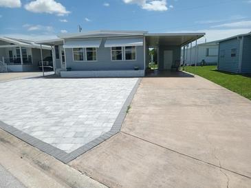 Charming home featuring a newly paved driveway and covered parking area, offering convenience and curb appeal at 5112 Glen Echo Ave, Sarasota, FL 34234