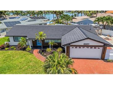 Charming single-story home featuring a well-manicured lawn and inviting curb appeal at 8001 13Th S Ave, St Petersburg, FL 33707