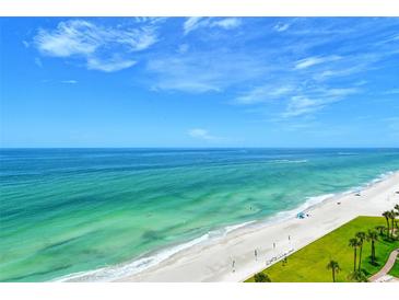Scenic beach view of pristine white sand and emerald waters under a bright, sunny sky at 1000 Longboat Club Road # 1105, Longboat Key, FL 34228