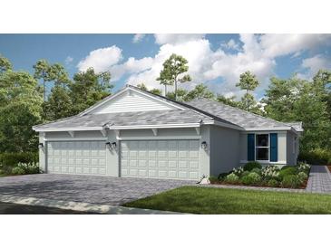 New construction home showing a three car garage, stone accents and manicured landscaping at 3114 Torta Ct, Bradenton, FL 34211