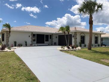 Single-story home with a white exterior and landscaping at 525 Medici Ct, Punta Gorda, FL 33950