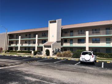 Two-story condo building with parking and a landscaped area at 175 Kings Hwy # 411, Punta Gorda, FL 33983