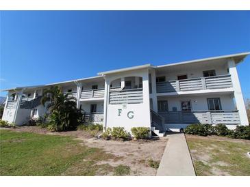 Building exterior of Fiddlers Green Condominiums, featuring a clean, modern design and landscaping at 6800 Placida Rd # 144, Englewood, FL 34224
