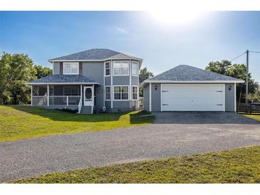 Two-story house with attached garage and spacious yard at 16115 Aralia Dr, Punta Gorda, FL 33955