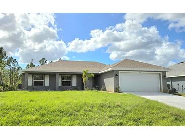 One-story home with gray siding and a two-car garage at 321 Gaynor Ln, Port Charlotte, FL 33953