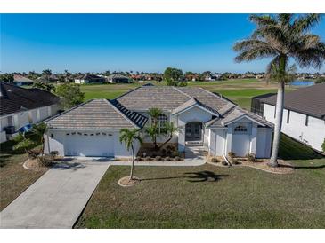 Single-story home with tile roof, two-car garage, and landscaped lawn at 3853 Bordeaux Dr, Punta Gorda, FL 33950