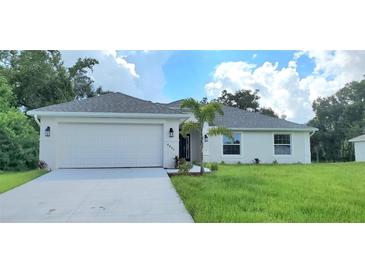 One-story home with attached garage and landscaped yard at 4051 Dotham St, Port Charlotte, FL 33948