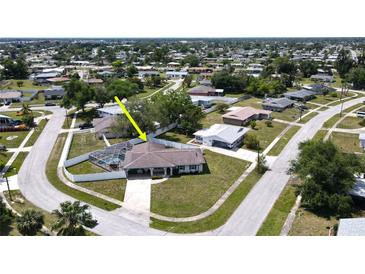 Aerial view of single-Gathering home with pool and fenced backyard, located in a residential neighborhood at 22260 Aburto Ln, Port Charlotte, FL 33952
