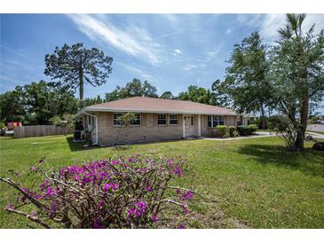 Brick ranch house with well-maintained lawn at 20567 Midway Blvd, Port Charlotte, FL 33952