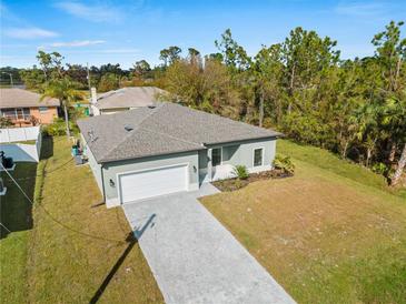Single-Gathering home with two-car garage and paver driveway at 12550 Mohican Ave, Port Charlotte, FL 33953