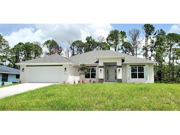 Newly built home with grey roof, white exterior, and landscaping at 2536 Jacobs St, Port Charlotte, FL 33953