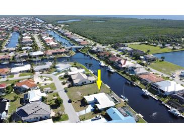 Aerial view showcasing a waterfront lot with canal access in a residential community at 2817 Coral Way, Punta Gorda, FL 33950