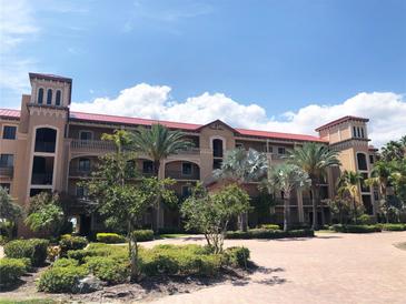 Attractive 2-story building with red tile roof, balconies, and lush landscaping at 87 Vivante Blvd # 8742, Punta Gorda, FL 33950