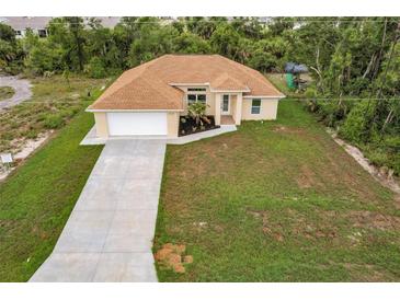 New construction home with driveway and lawn at 820 Bowman Ter, Port Charlotte, FL 33953