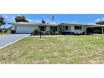 Ranch-style home with white exterior and landscaping at 1629 Birchcrest Blvd, Port Charlotte, FL 33952