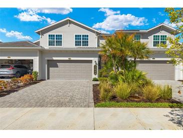 Two-story townhome with attached garage and landscaped front yard at 15999 Grassland Ln # 3221, Punta Gorda, FL 33982