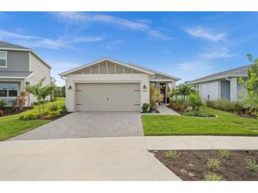 Craftsman style home with a landscaped yard at 43789 Cattleman Dr, Punta Gorda, FL 33982