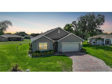 Single-story house with a two-car garage and landscaped yard at 27441 Natal Dr, Punta Gorda, FL 33983