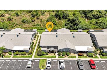 Aerial view of a condo building with parking and surrounding landscape at 3300 Loveland Blvd # 1301, Punta Gorda, FL 33980