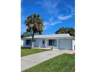 Cute one-story home with palm tree and driveway at 1286 Hillcrest Nw Ave, Port Charlotte, FL 33948