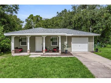 Charming one-story house with covered porch and attached garage at 265 Tipton St, Port Charlotte, FL 33954
