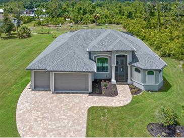 Aerial view of a single-Gathering home with three-car garage at 14041 Clarissa Ln, Port Charlotte, FL 33981