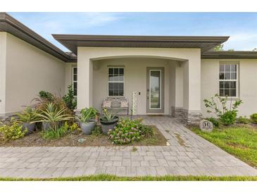 Exterior view showing the front entrance with a covered porch and landscaped walkway at 16195 Maya Cir, Punta Gorda, FL 33955