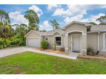 Well-maintained house with a two-car garage and manicured lawn at 5272 Boxer St, North Port, FL 34288