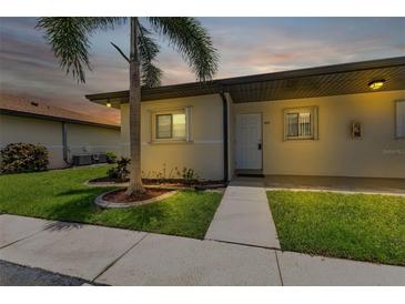 Neat condo exterior with a walkway and landscaping at dusk at 25275 Rampart Blvd # 1801, Punta Gorda, FL 33983