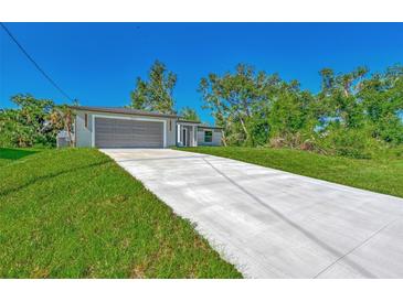 New construction home with gray garage door and concrete driveway at 3847 E Price Blvd, North Port, FL 34288