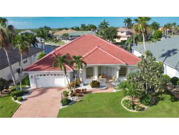 House with red tile roof and landscaped yard at 2259 Ryan Blvd, Punta Gorda, FL 33950