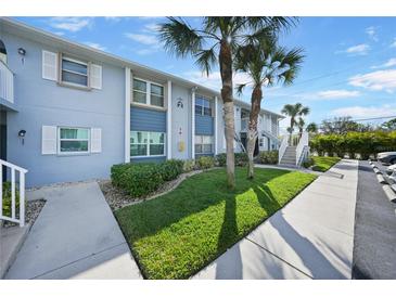 Condo building exterior with walkway and landscaping at 25050 Sandhill Blvd # A4 Bldg 2, Punta Gorda, FL 33983