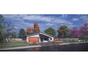 Modern home with a wood garage door and landscaped front yard at 18412 Robinson Ave, Port Charlotte, FL 33948