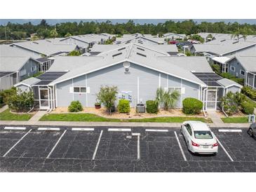 Aerial view of a community of villas with ample parking at 3300 Loveland Boulevard # 1904, Port Charlotte, FL 33980