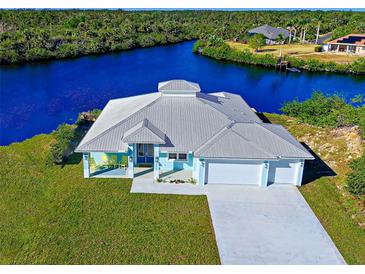 Waterfront home boasting a two-car garage and canal views at 2239 Cornelius Blvd, Port Charlotte, FL 33953
