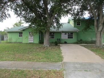 Green house with a large yard at 5893 Mayberry Ave, North Port, FL 34287