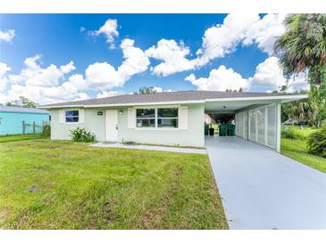 Charming single story home with carport and well-maintained lawn at 785 Chevy Chase St, Port Charlotte, FL 33948