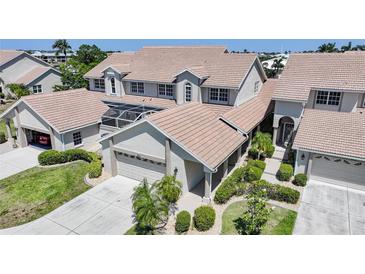 Beautiful two-story home with a tile roof, attached garage, landscaped yard, and screened-in patio at 3800 Bal Harbor Blvd # 212, Punta Gorda, FL 33950